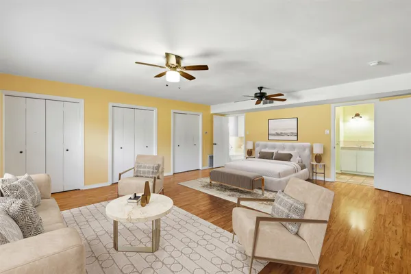 a living room with furniture and a wooden floor