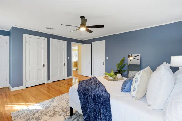 a bedroom with two beds and painting on the wall