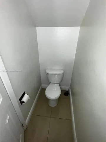 a view of staircase with lots of windows and white walls