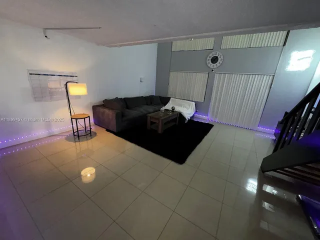 a living room with furniture and a rug