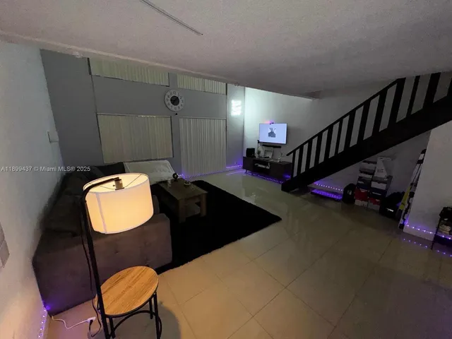 a living room with furniture and a chair