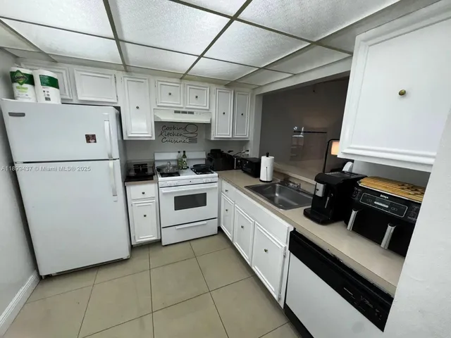 a kitchen with a sink a stove and refrigerator
