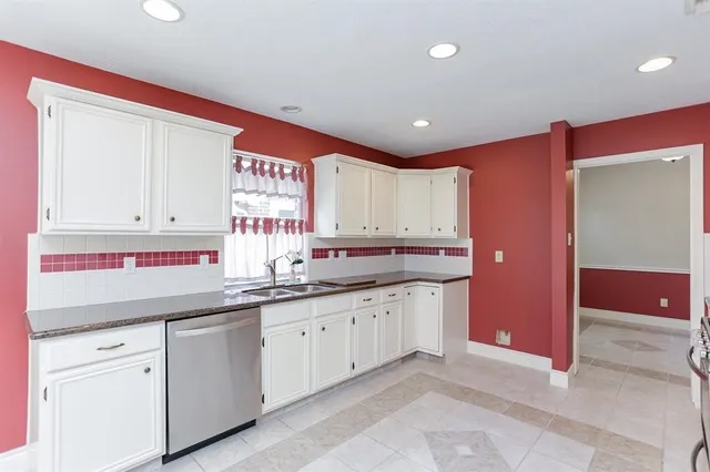 a kitchen with granite countertop a sink and dishwasher