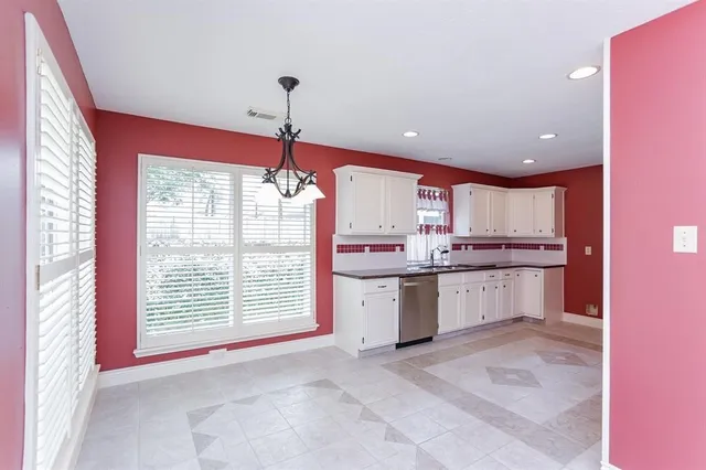 a kitchen with a refrigerator sink cabinets and a window
