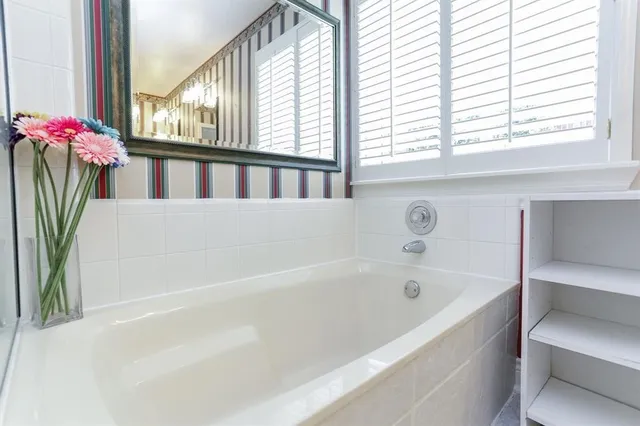 a white bath tub sitting next to a window