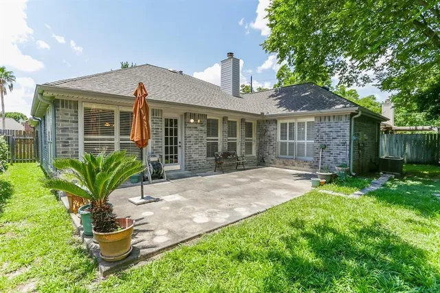 a front view of a house with a yard and potted plants