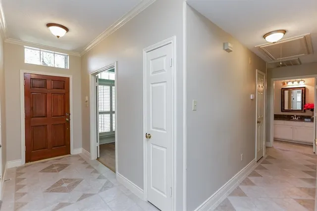 a view of a hallway with a livingroom and a bathroom