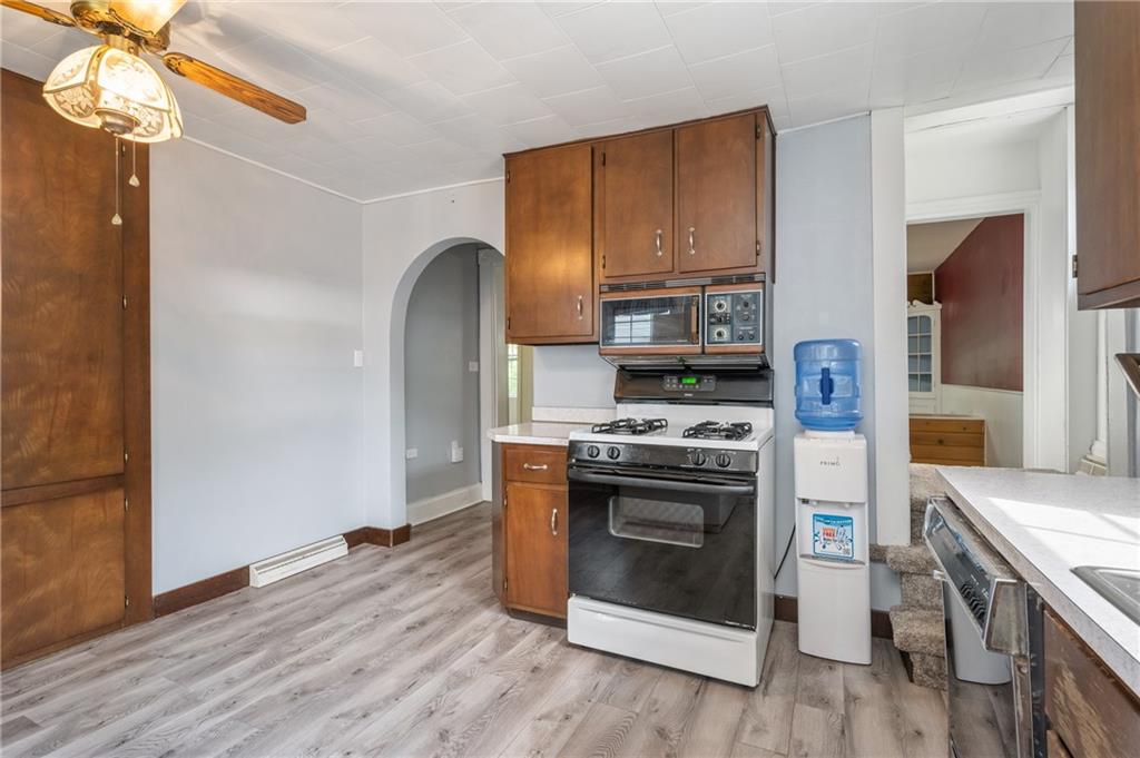 246 Olive Street Hunker, PA 15639 - Photo 11 of 27 a kitchen with a stove a sink and a refrigerator