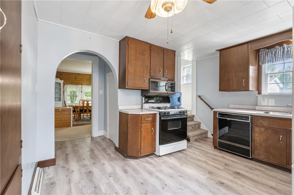 246 Olive Street Hunker, PA 15639 - Photo 13 of 27 a kitchen with wooden floors and stainless steel appliances