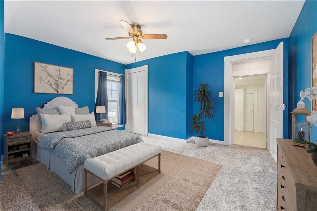246 Olive Street Hunker, PA 15639 - Photo 15 of 27 a bedroom with a bed and a chandelier