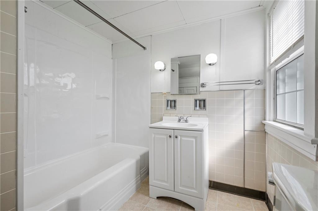 246 Olive Street Hunker, PA 15639 - Photo 20 of 27 a bathroom with a tub sink and mirror