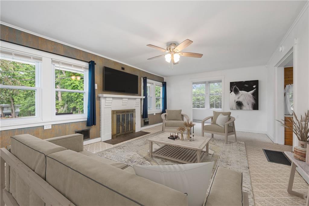 246 Olive Street Hunker, PA 15639 - Photo 7 of 27 a living room with fireplace furniture and a large window