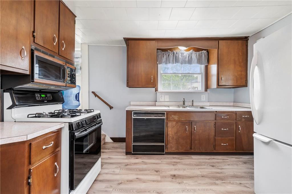 246 Olive Street Hunker, PA 15639 - Photo 10 of 27 a kitchen with granite countertop a stove a sink and a microwave