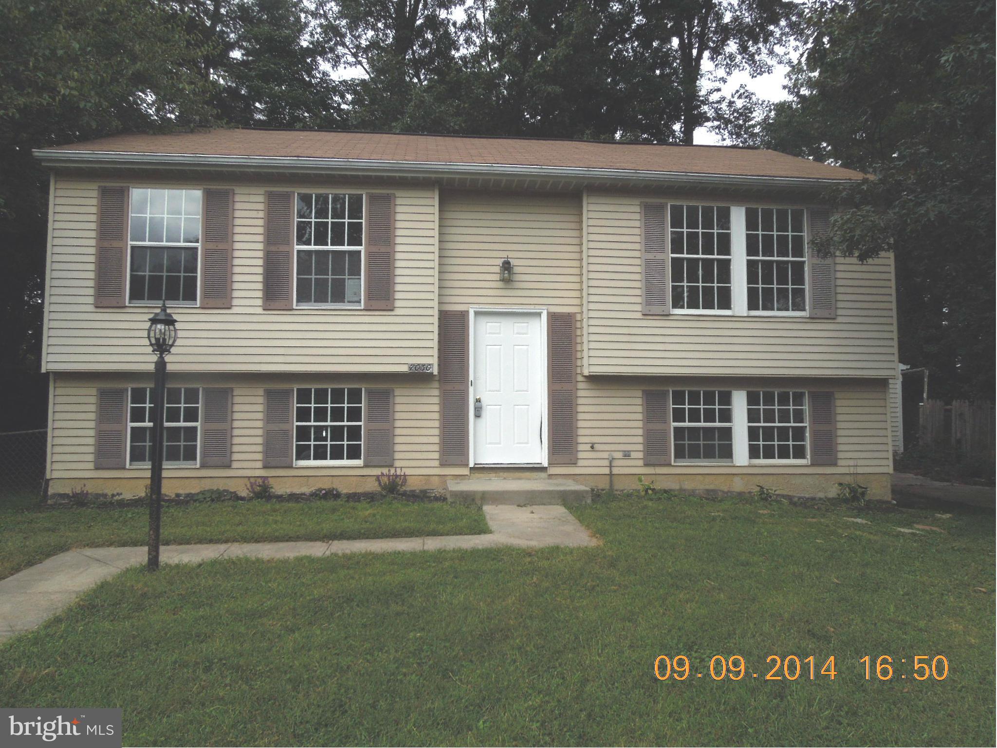 7030 Johnnycake Road Baltimore, MD 21228 - Photo 1 of 22 a front view of a house with a garden
