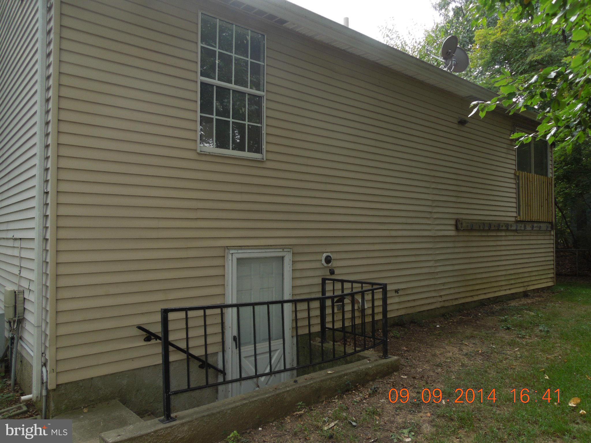 7030 Johnnycake Road Baltimore, MD 21228 - Photo 19 of 22 a view of a house with a yard