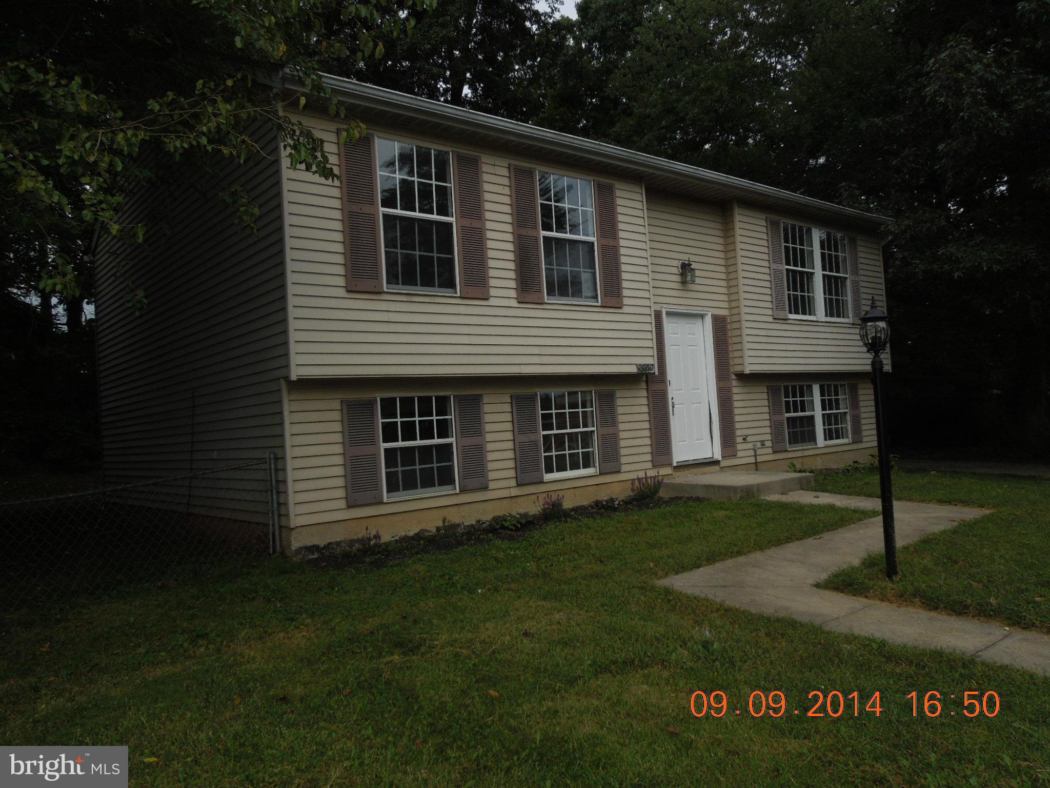 7030 Johnnycake Road Baltimore, MD 21228 - Photo 20 of 22 a front view of a house with a garden