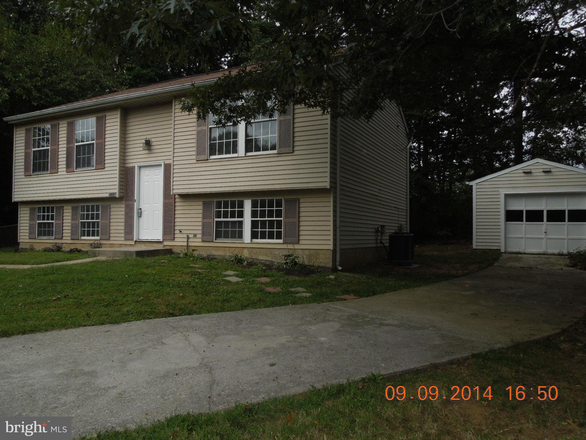 7030 Johnnycake Road Baltimore, MD 21228 - Photo 21 of 22 a front view of a house with a yard
