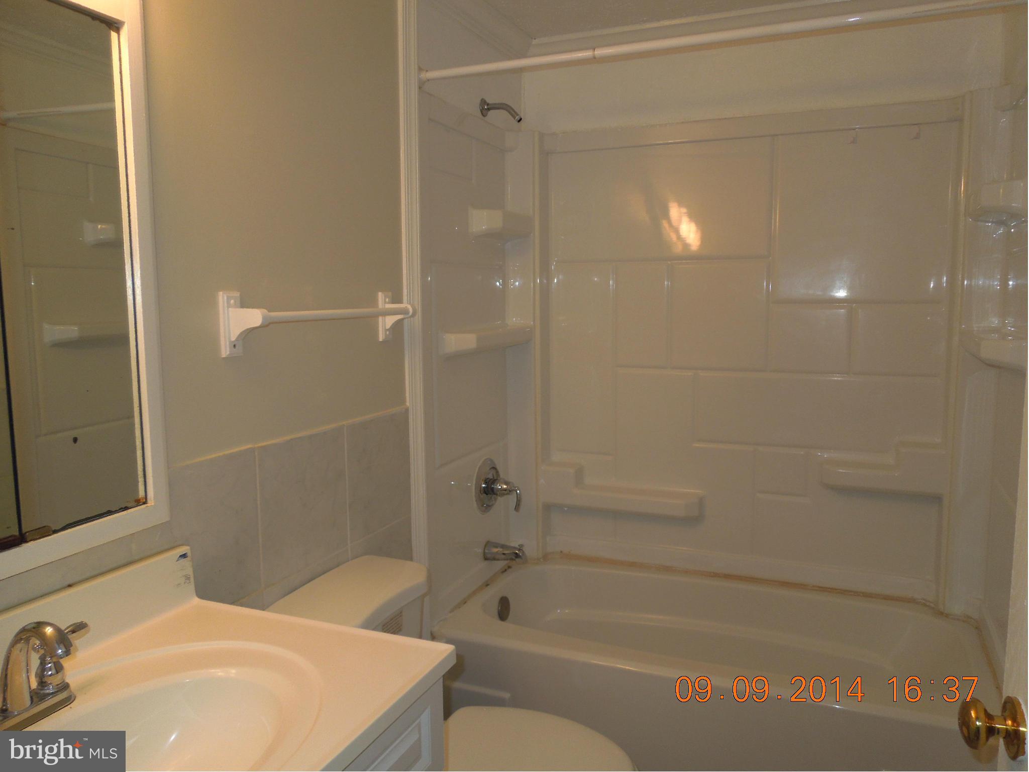 7030 Johnnycake Road Baltimore, MD 21228 - Photo 10 of 22 a bathroom with a sink a toilet and shower