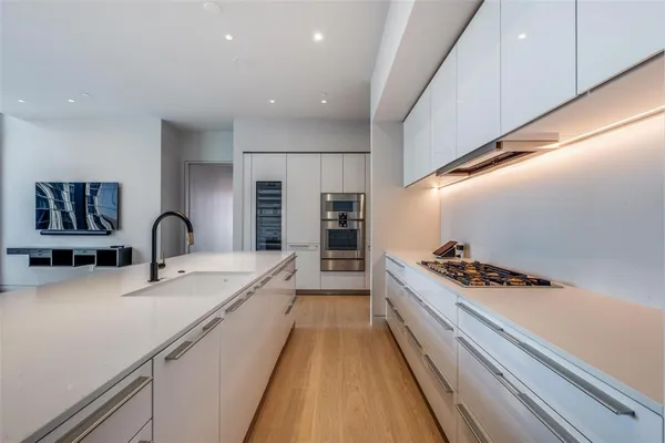 a view of a kitchen with a sink and a large window