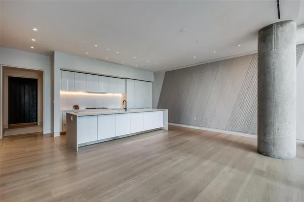 a kitchen with white cabinets and a sink