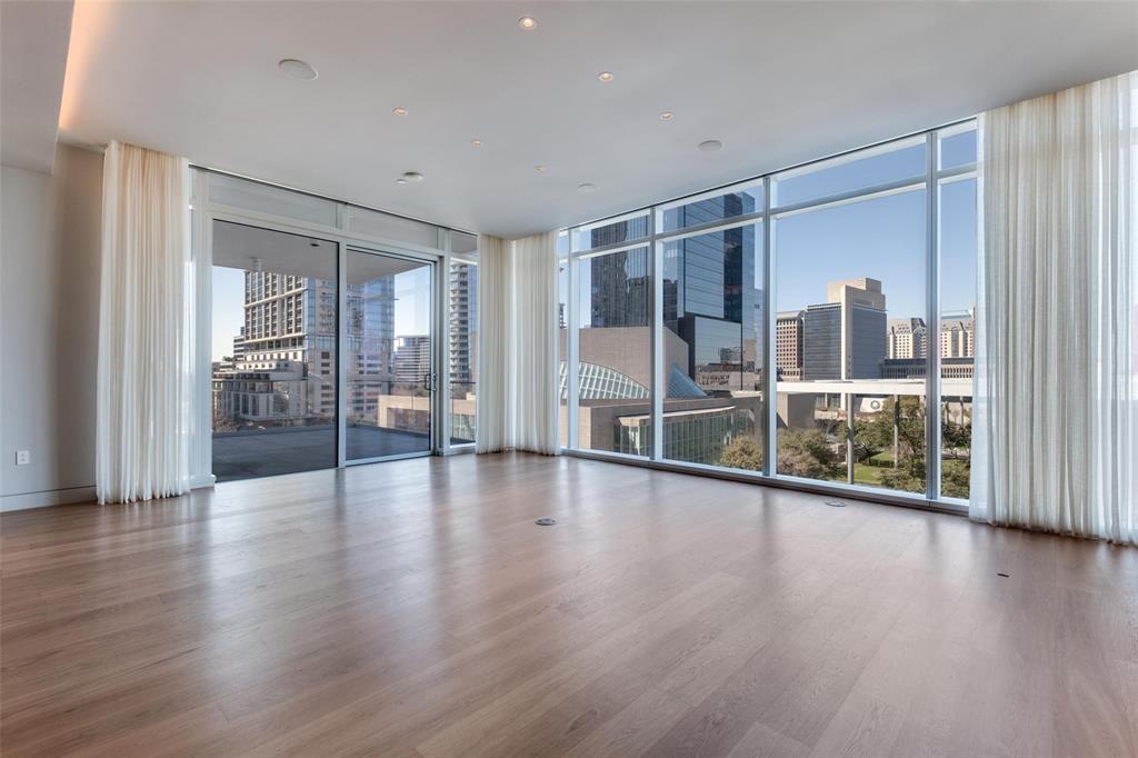 1747 Leonard Street, Unit 403 Dallas, TX 75201 - Photo 14 of 33 a view of a big room with wooden floor and windows