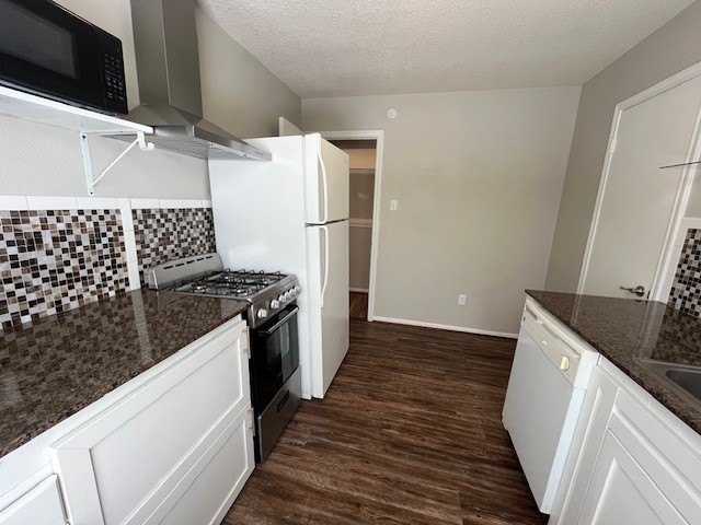 a kitchen with granite countertop a sink and a stove top oven