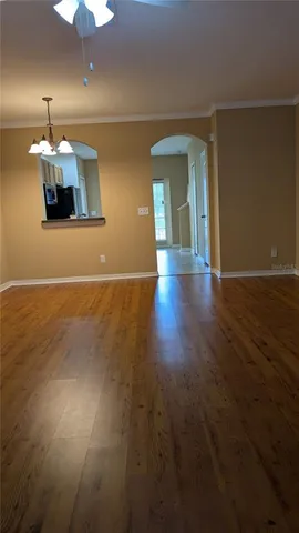 a view of a room with wooden floor