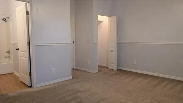 an empty room with wooden floor and a window