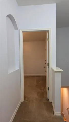 a view of a hallway with wooden shelves