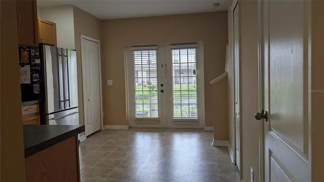 a view of a entrance and room with wooden floor