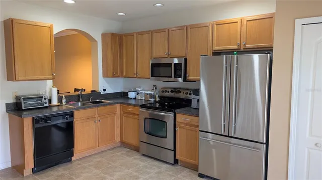 a kitchen with granite countertop stainless steel appliances and cabinets