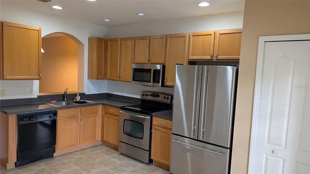a kitchen with a refrigerator sink and stove
