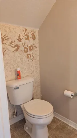 a white toilet sitting next to a bathroom sink