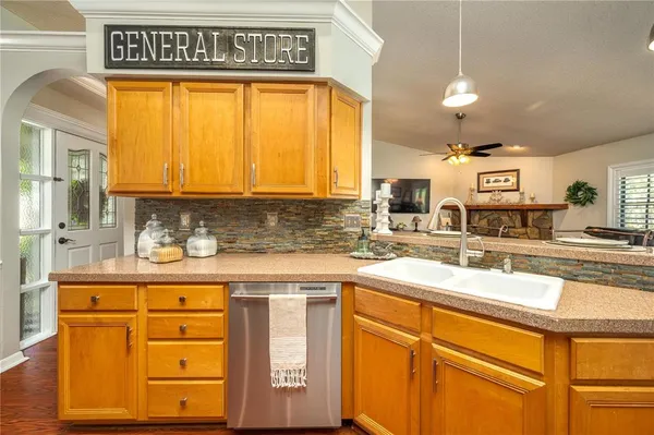 a kitchen with stainless steel appliances granite countertop a sink and cabinets