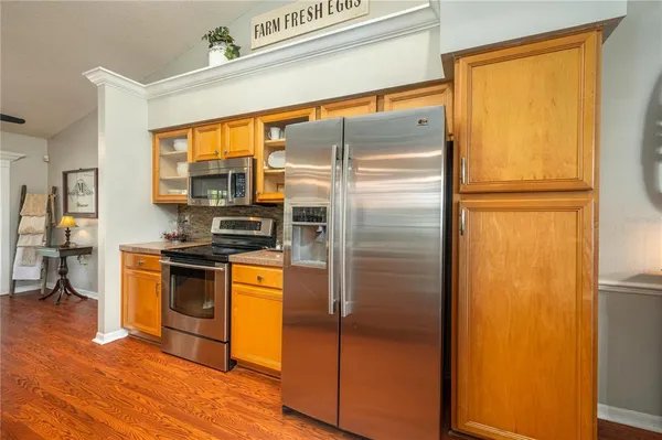 a kitchen with stainless steel appliances a refrigerator and a stove top oven