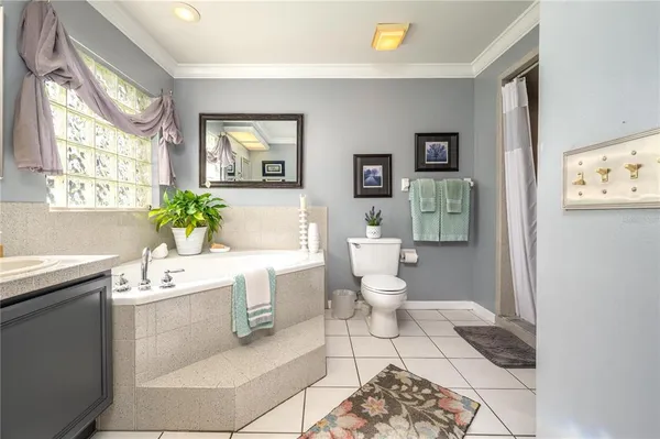 a living room with a toilet a sink and a mirror