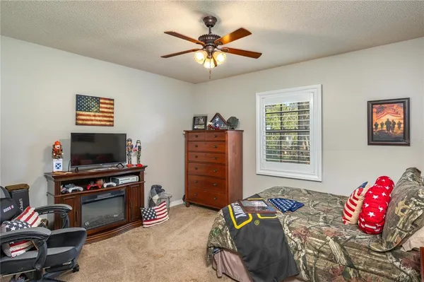 a bedroom with furniture and a flat screen tv