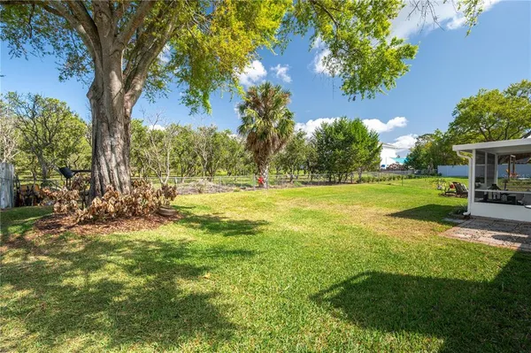 a view of a house with swimming pool and sitting area