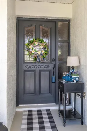 a living room with a table and a potted plant