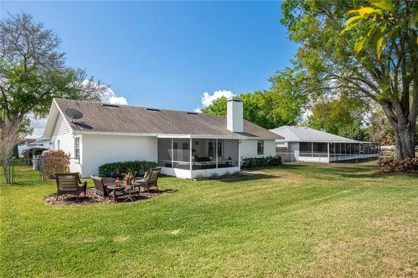 a view of a house with swimming pool and a yard