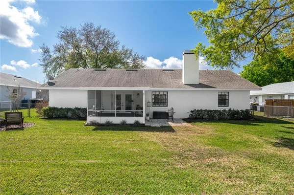 a backyard of a house with table and chairs