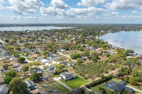 a view of a house with outdoor seating and a yard
