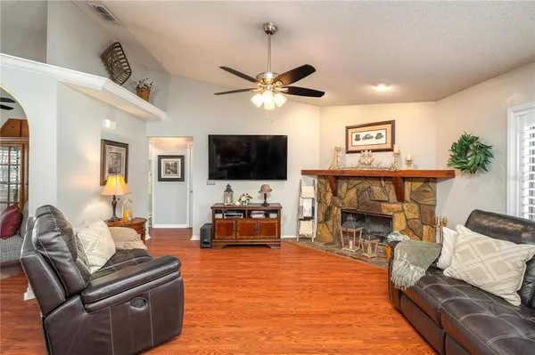 a living room with furniture a fireplace and a flat screen tv