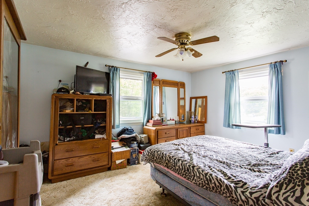 12 Hadley Path West Brookfield, MA 01585 - Photo 13 of 28 a bed room with a bed and a television