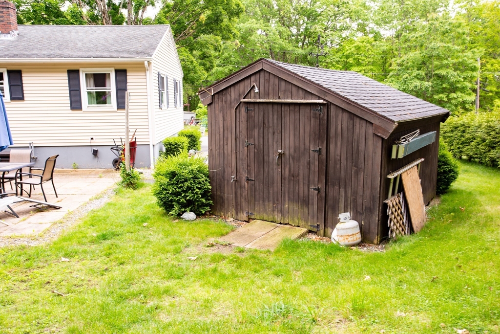 12 Hadley Path West Brookfield, MA 01585 - Photo 26 of 28 a backyard of a house with table and chairs