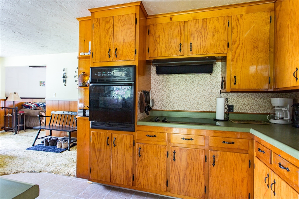 12 Hadley Path West Brookfield, MA 01585 - Photo 8 of 28 a kitchen with granite countertop wooden cabinets and stainless steel appliances