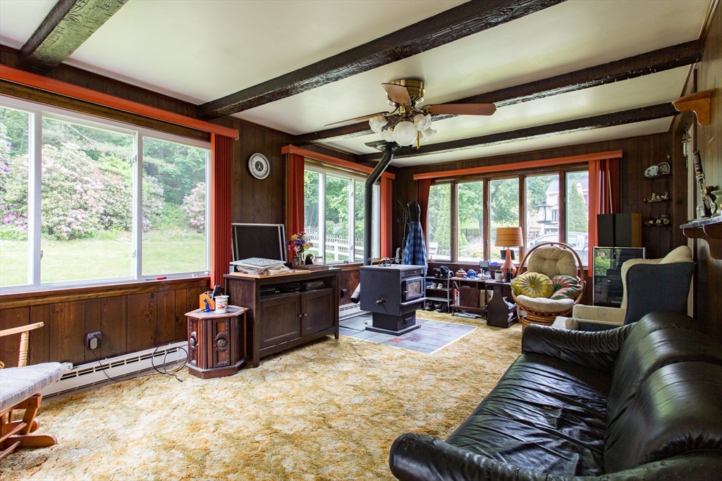12 Hadley Path West Brookfield, MA 01585 - Photo 9 of 28 a living room with furniture floor to ceiling window and a potted plant