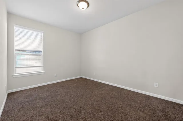 a kitchen with granite countertop a sink cabinetry and chandelier