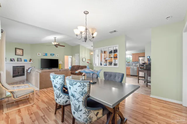 a kitchen with stainless steel appliances granite countertop a refrigerator sink and stove