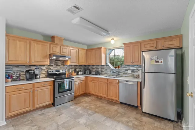 a kitchen with a stove top oven sink and cabinets